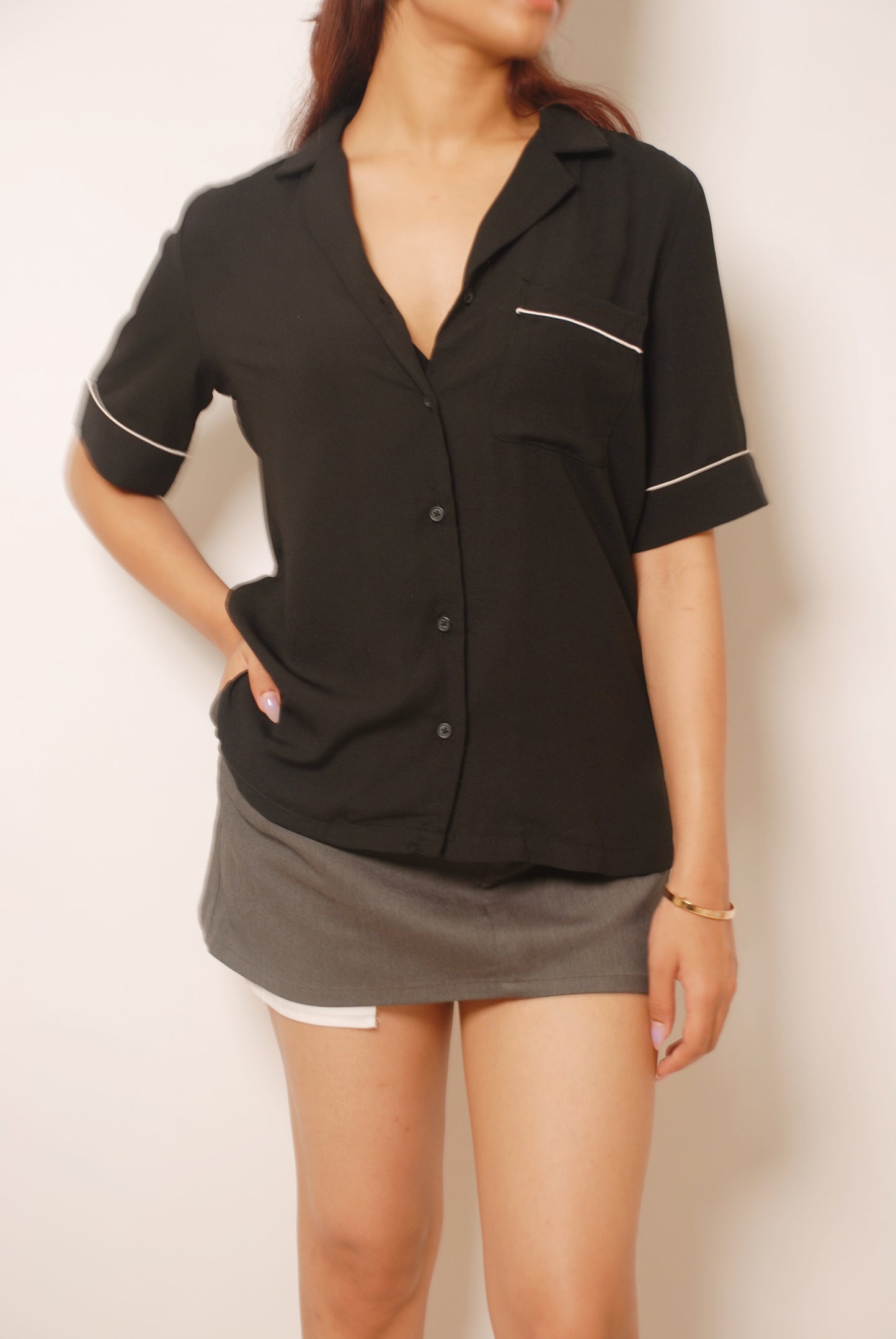 Black open collar shirt with white piping