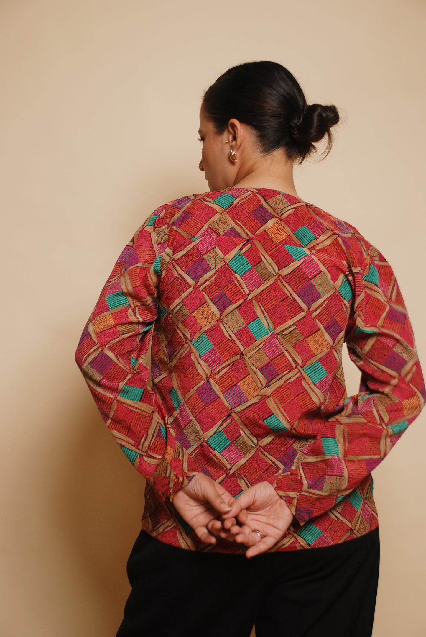 Pink printed blouse with gold ornamental buttons