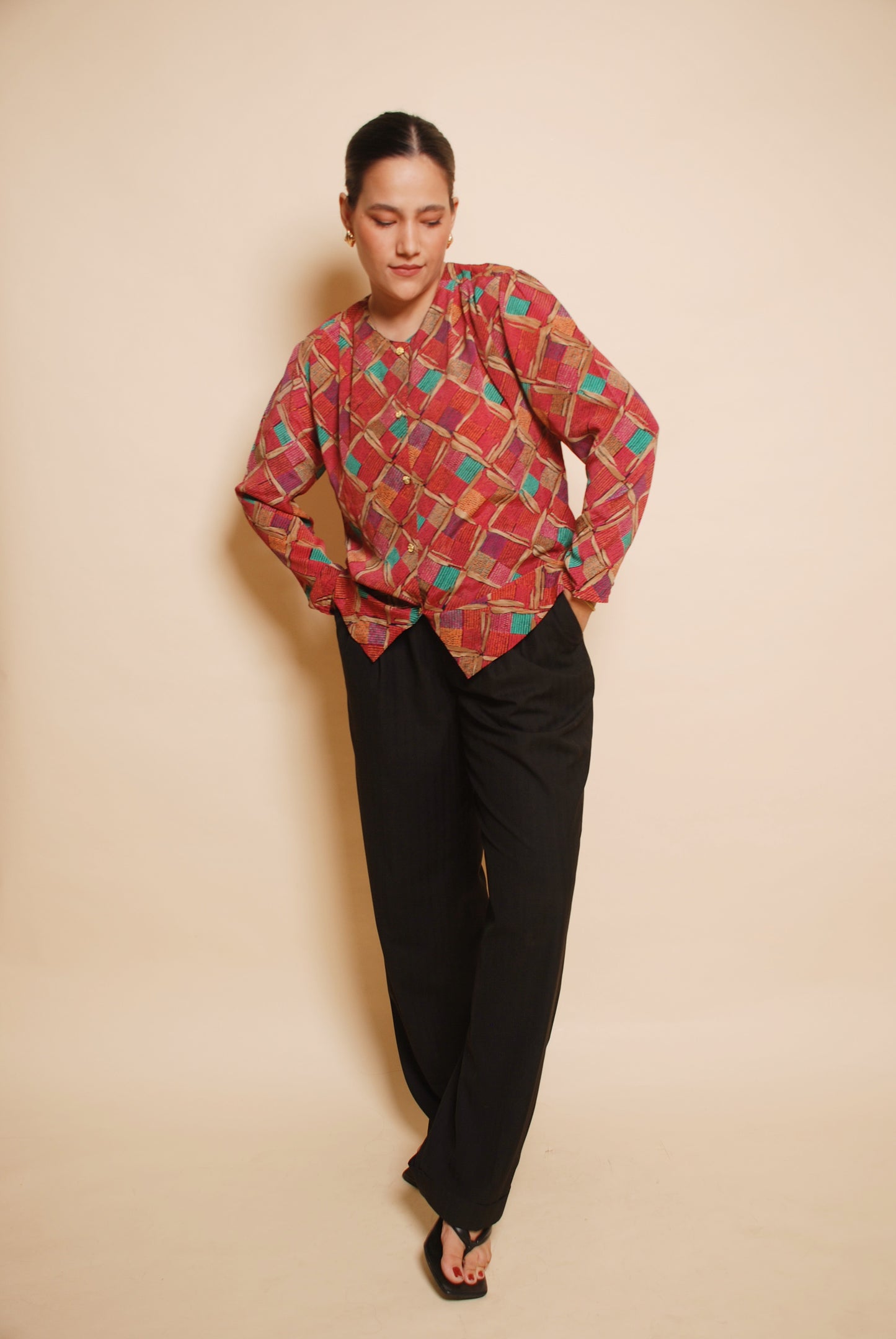 Pink printed blouse with gold ornamental buttons